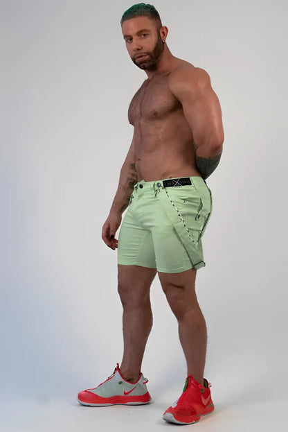 Light green romey shorts with black belt and stitched detailing in durable cargo fabric for casual wear