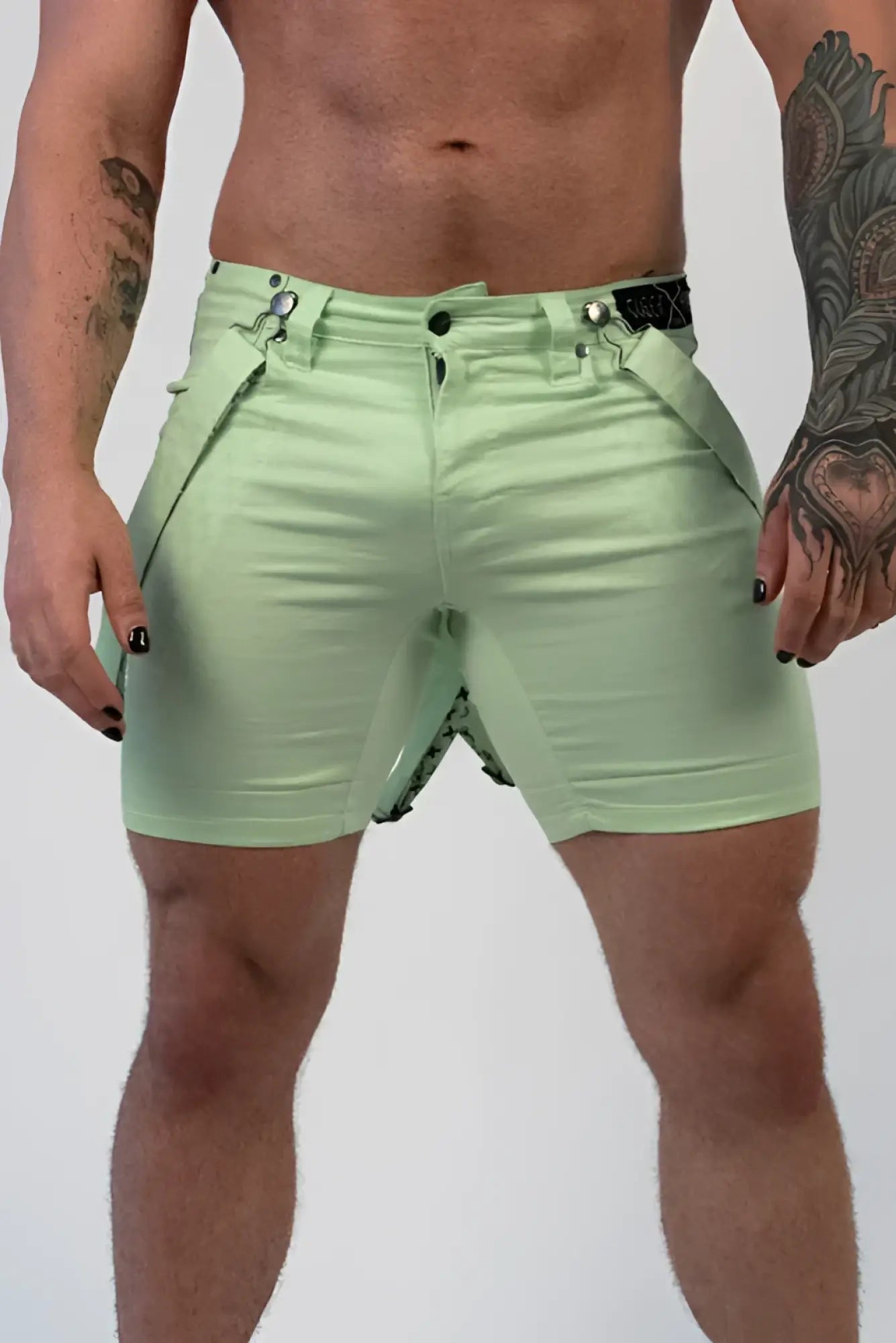 Romey shorts in light green with sleek fit and black belt accents showcasing a modern design