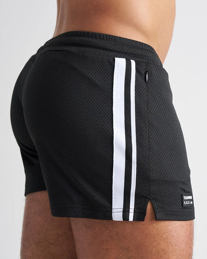 Black mesh athletic shorts with two white side stripes and a small brand tag on the lower right leg for s s c fraternity 3 inch mesh short