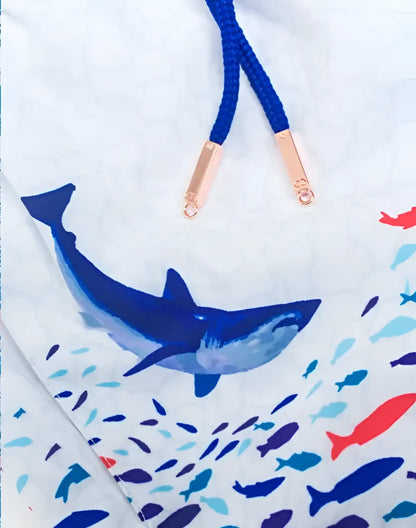 White swim trunks with bold blue shark and colorful fish print navy drawstrings and rose gold metal tips s50 seascape print