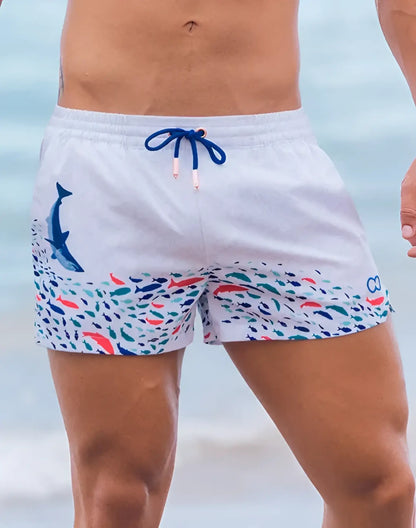 White s50 seascape print swim shorts with vibrant underwater dolphin and fish design and navy drawstring waistband