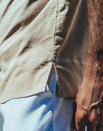 Beige Santorini linen shirt with delicate white leaf embroidery along the seam in lightweight breathable fabric
