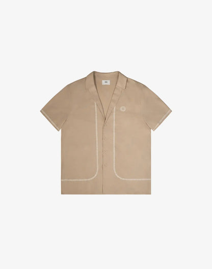 Beige santorini linen shirt with short sleeves button-up front contrasting stitching and small embroidered logo on left chest