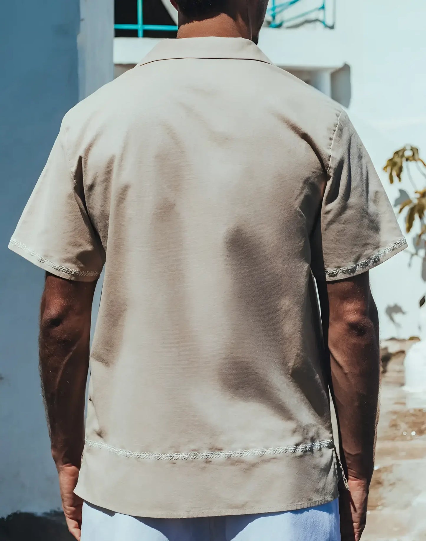 Beige santorini linen shirt with short sleeves and subtle embroidered trim on collar sleeve and bottom hem