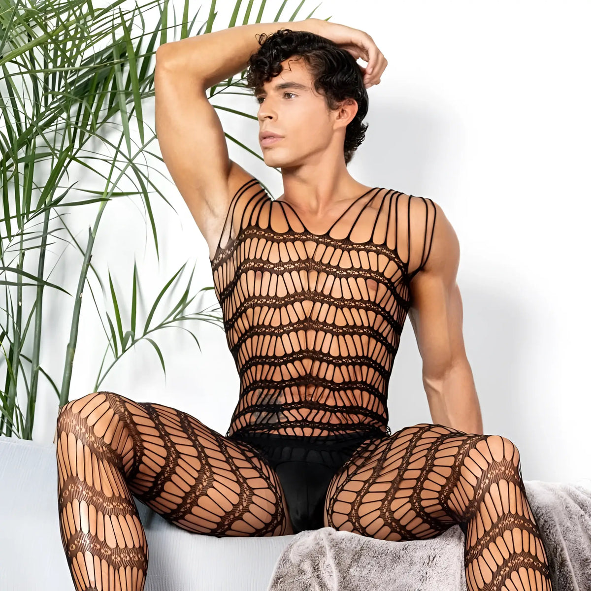 Black fishnet bodysuit with intricate lace patterns covering torso and legs from secret male smc001 bodysuit and harness