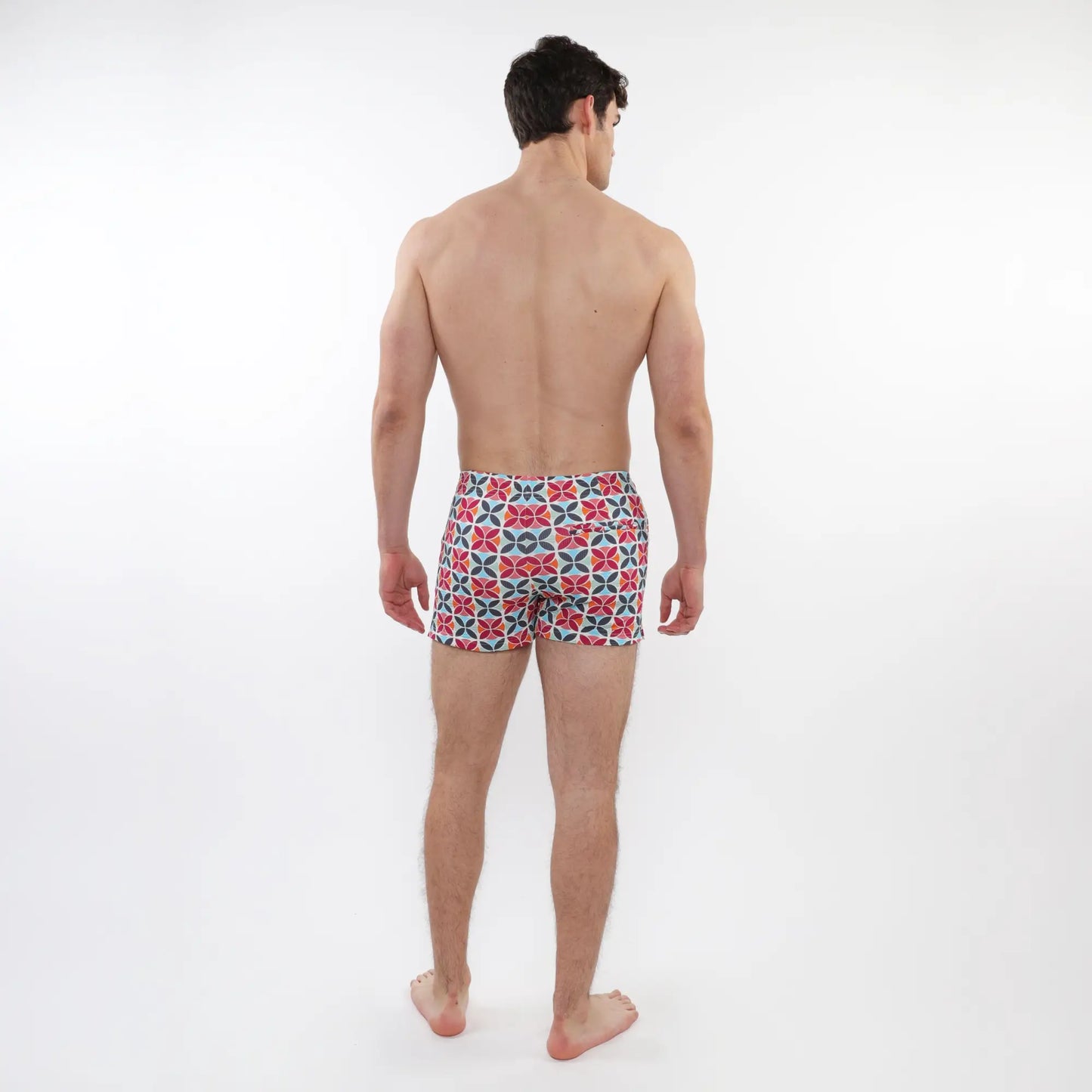 Men’s seersucker swim shorts with mesh lining featuring a bold red navy blue and white geometric pattern