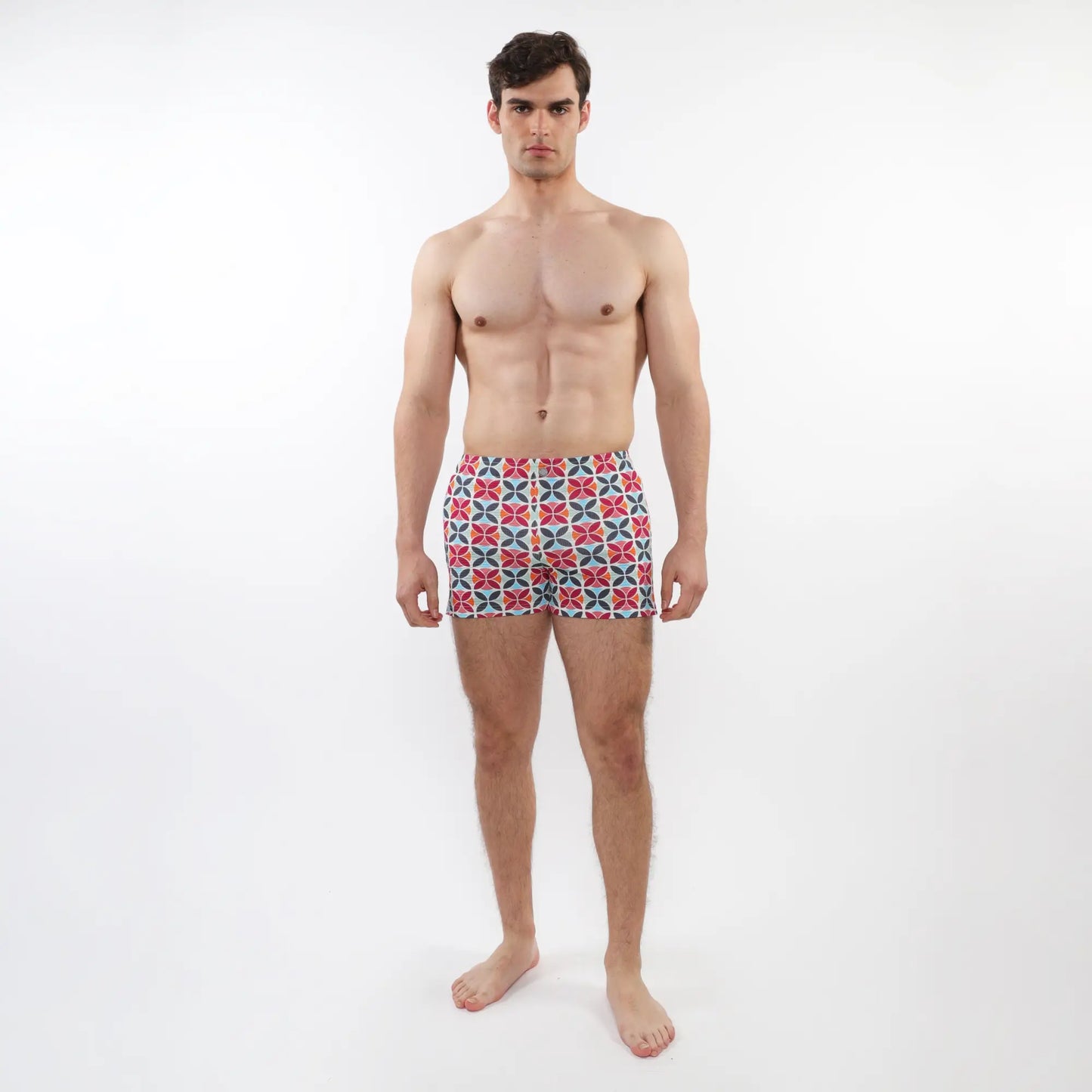 Men’s seersucker swim shorts with mesh lining featuring a vibrant red blue and white geometric pattern