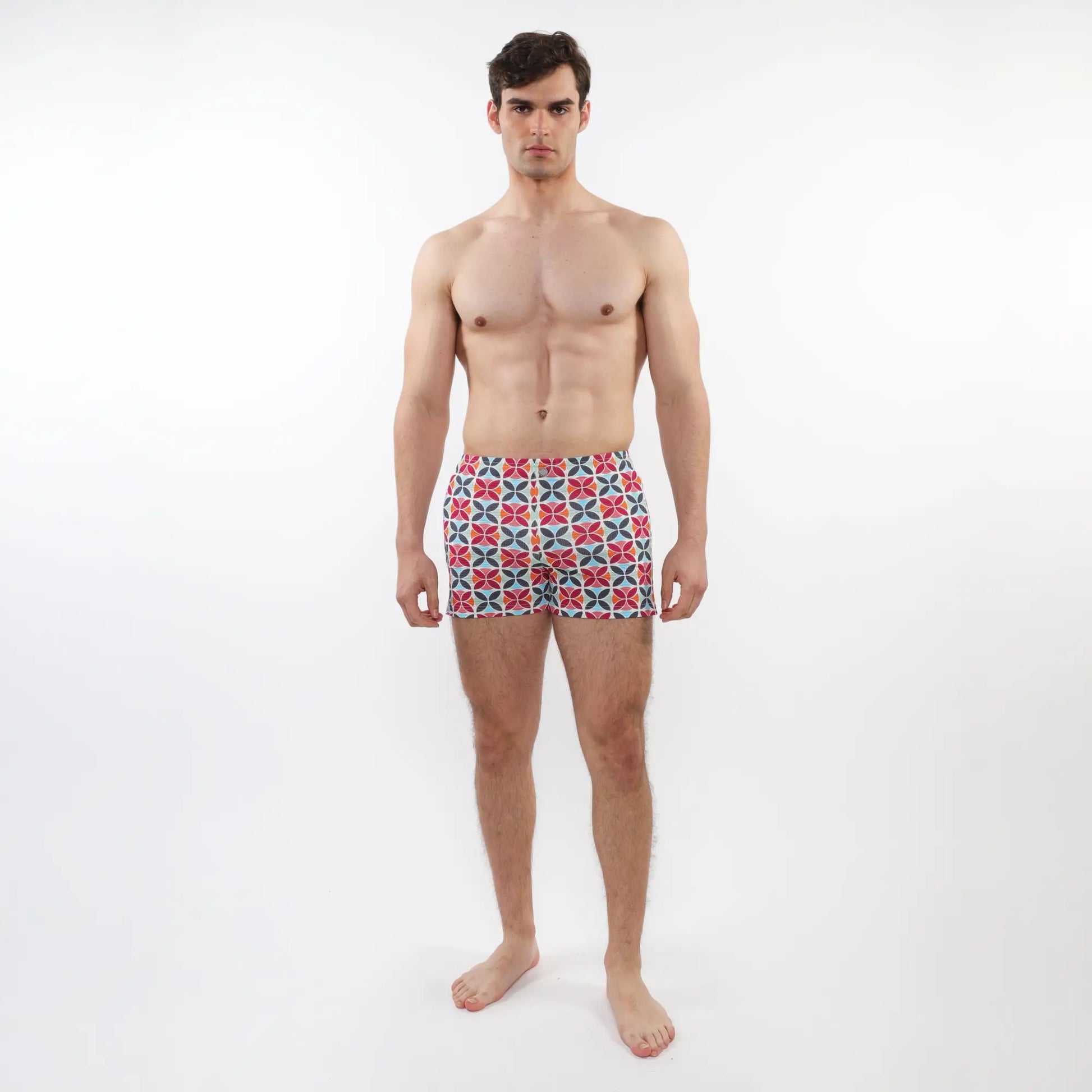 Men’s seersucker swim shorts with mesh lining featuring a vibrant red blue and white geometric pattern