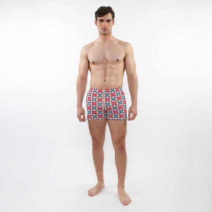 Men’s seersucker swim shorts with mesh lining featuring a vibrant red blue and white geometric pattern