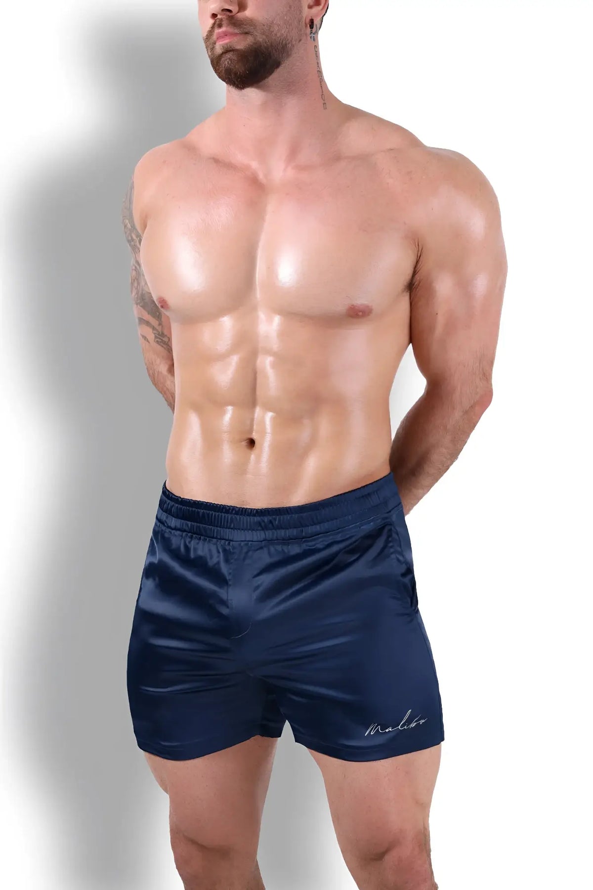 Navy satin shimmerflex active shorts with subtle embroidered logo on lower right leg for stylish comfort