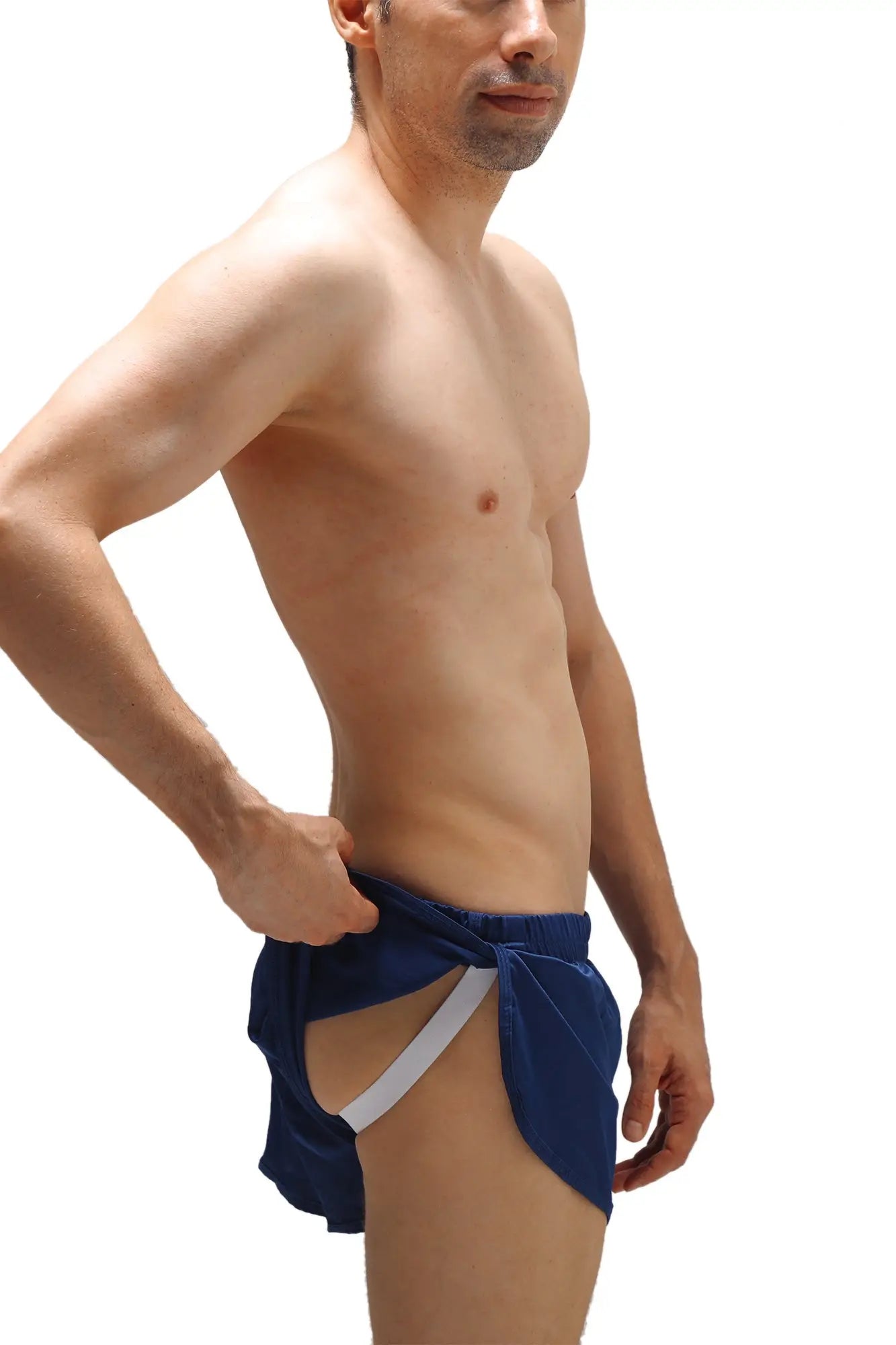 Navy blue velvet swim trunks with white elastic waistband and front tie detail featuring integrated jockstrap