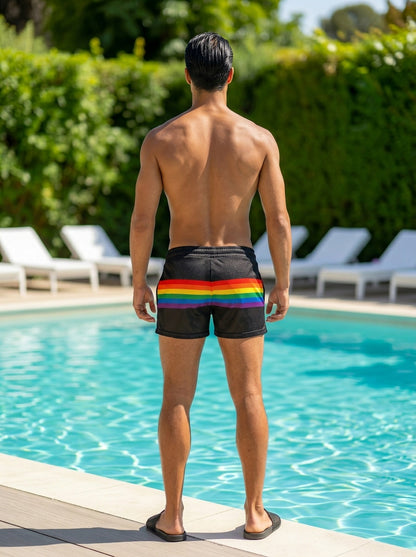 Black mesh swim shorts with a vibrant rainbow stripe across the waistband in rainbow stripe mesh shorts design