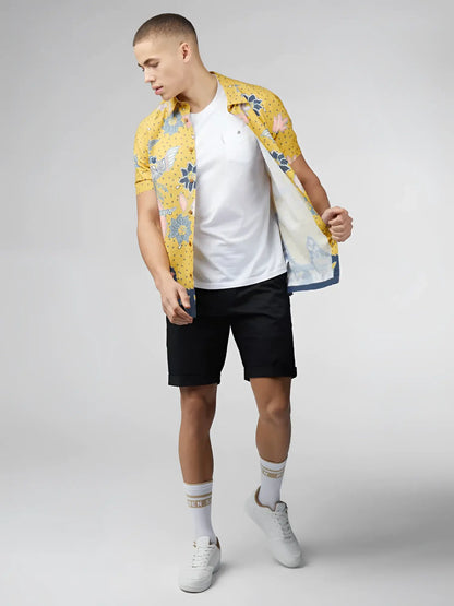 Yellow floral short-sleeved shirt with blue and pink accents featuring signature abstract botanical print design