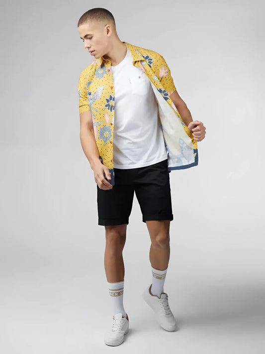 Yellow floral short-sleeved shirt with blue and pink accents featuring signature abstract botanical print design