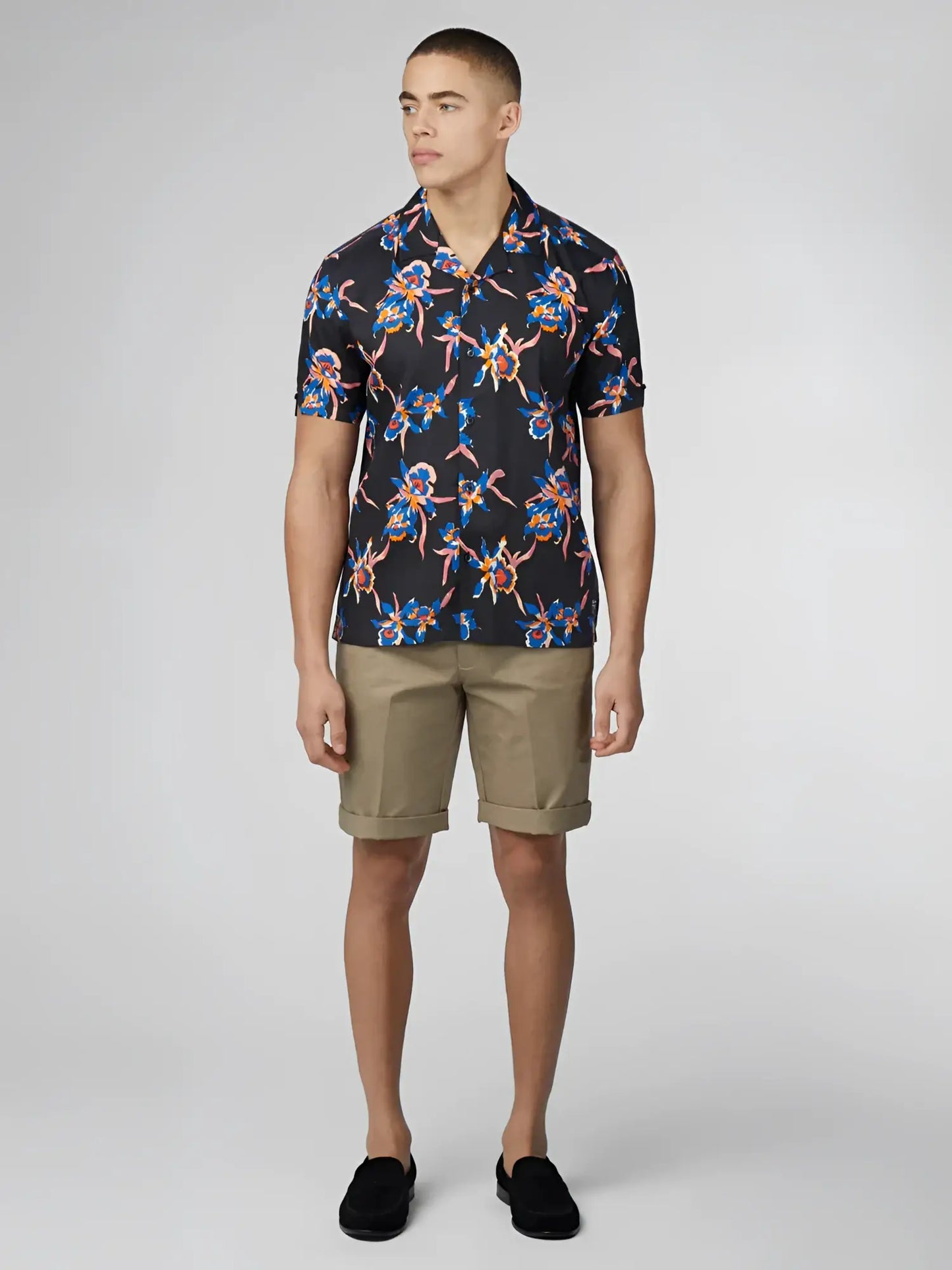 Black short-sleeved button-up shirt with signature botanical print in blue pink and orange floral pattern