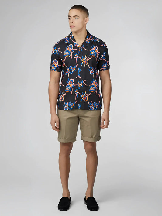 Black short-sleeved button-up shirt with signature botanical print in blue pink and orange floral pattern
