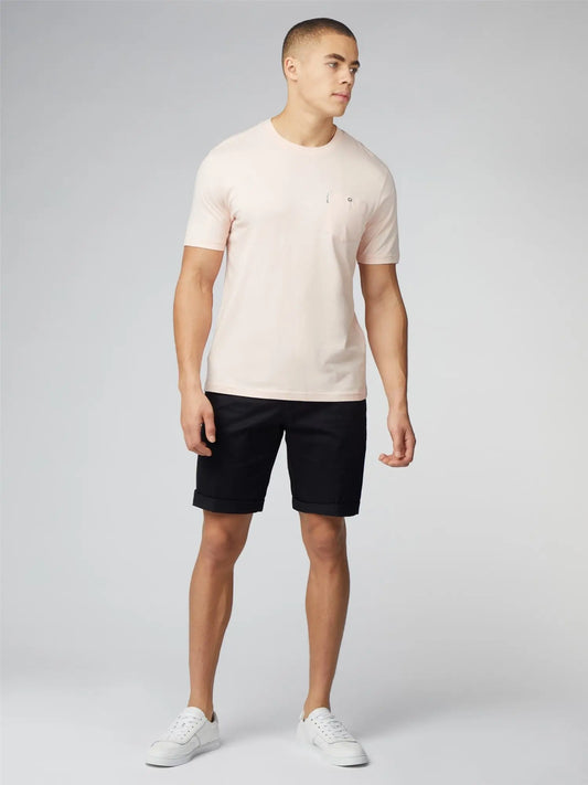 A pale pink short-sleeved crew neck signature t-shirt with a small embroidered chest pocket logo