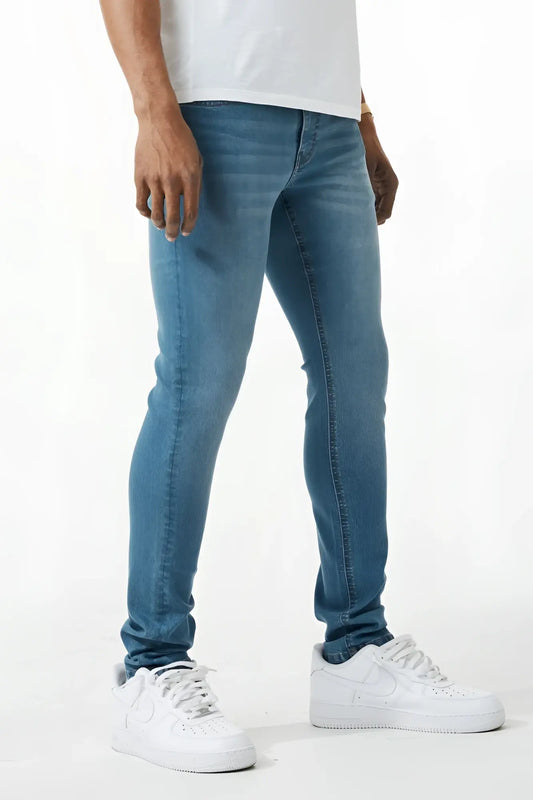 Blue skinny fit denim jeans with slim fit design five classic pockets and subtle fading on blue denim material