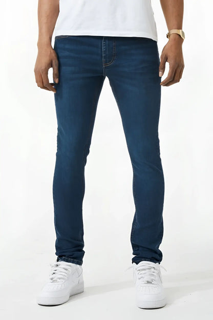 Dark blue skinny fit denim jeans with slim fit, classic five-pocket design, and subtle fading on thighs