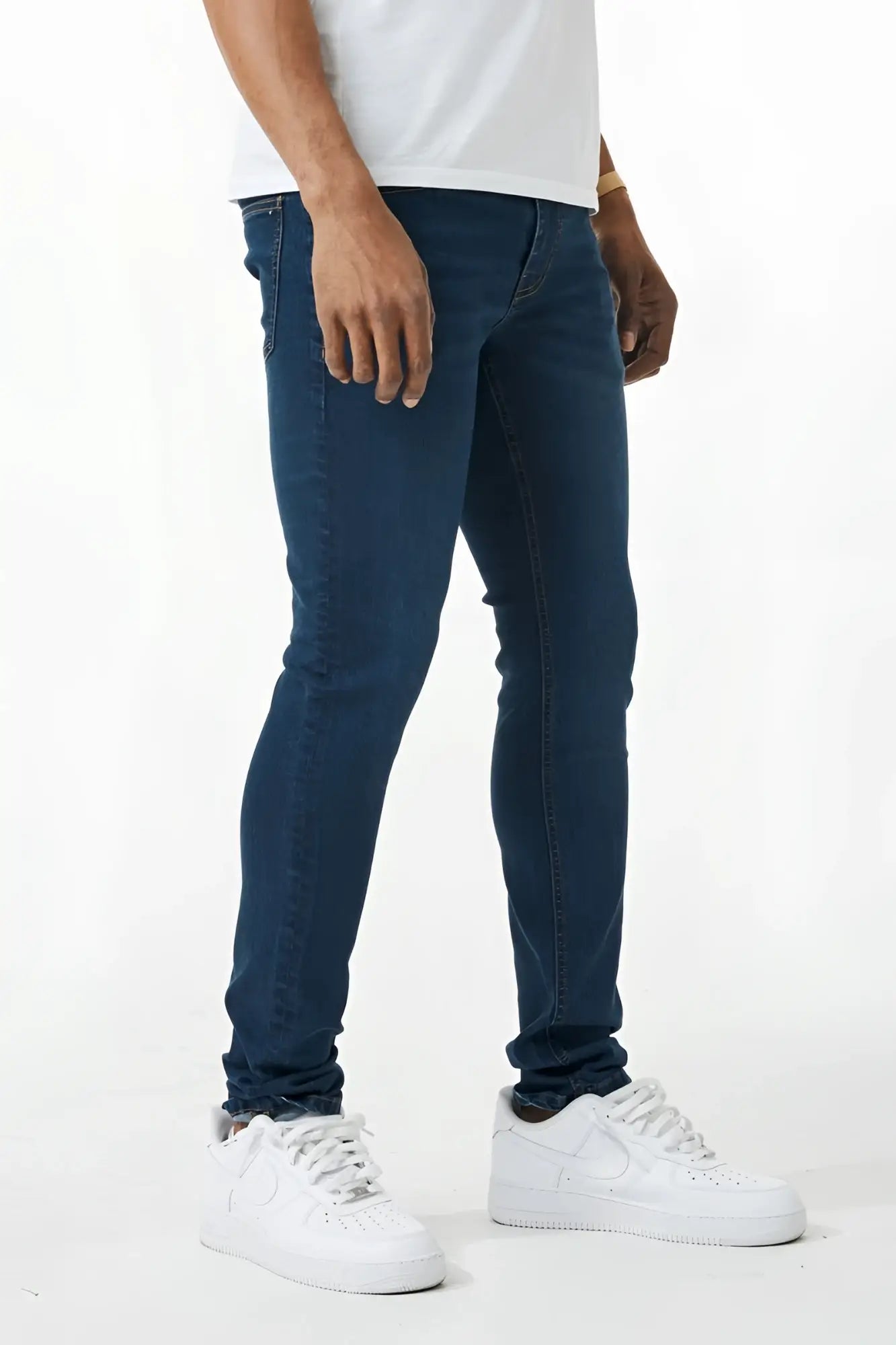 Dark blue skinny fit denim jeans with slim fit design, classic five pockets, and subtle thigh fading