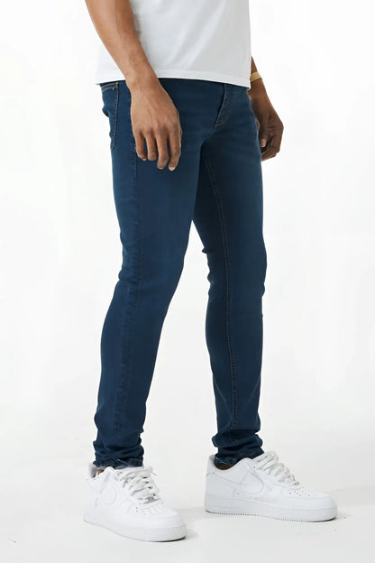 Dark blue skinny fit denim jeans with slim fit design, classic five pockets, and subtle thigh fading