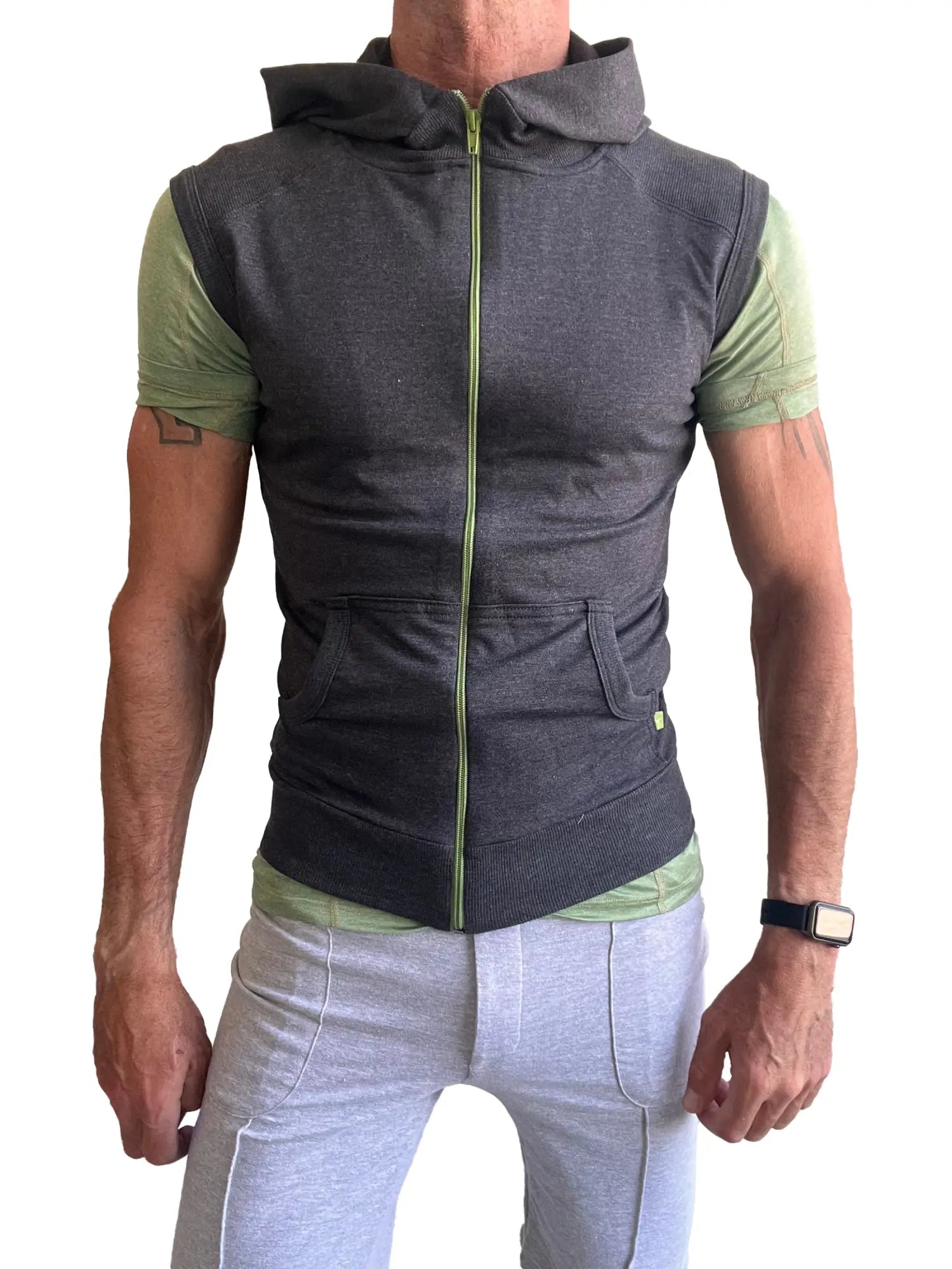 Sleeveless yoga hoodie charcoal gray in dark gray with lime green zipper and sleeve accents worn over matching shirt