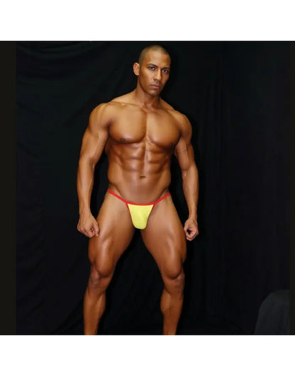 Men's bikini underwear in yellow with red trim featuring a low-rise cut shown on a model by Arroyman.