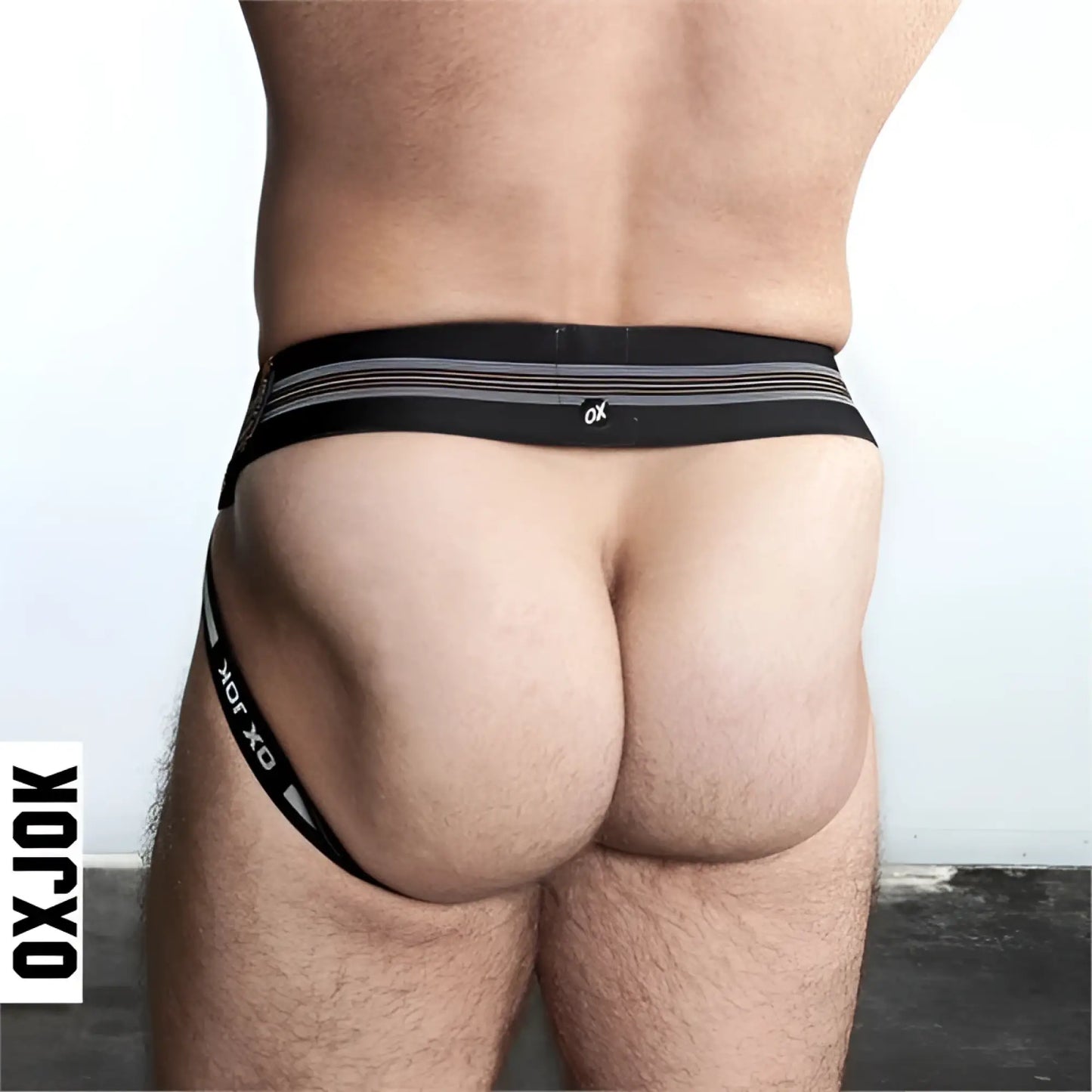 Black oxjok slingjock jockstrap with silver horizontal stripes and a small white logo on the waistband