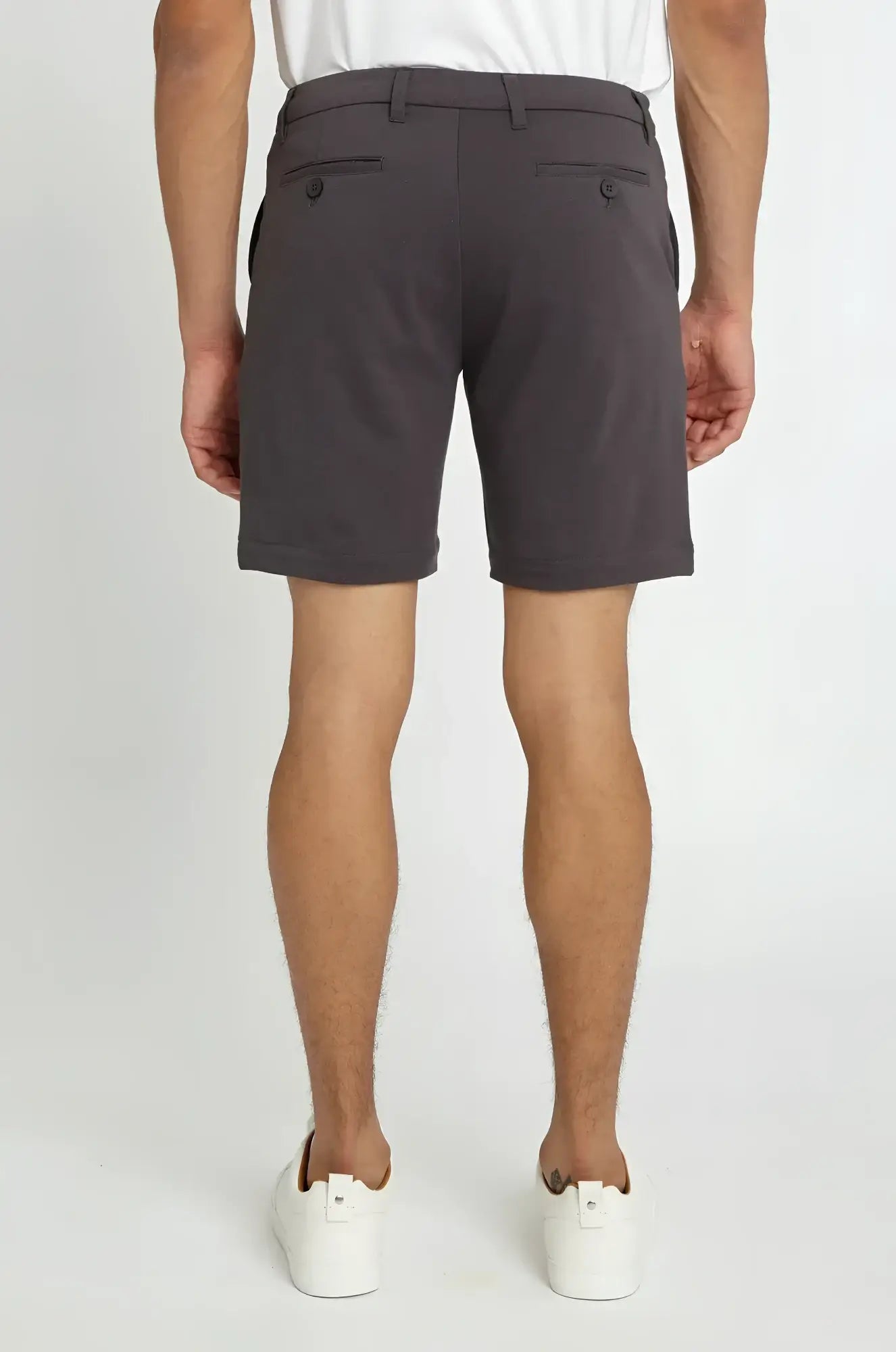 Dark gray solid stretch knit chino shorts with tailored fit and buttoned back pockets shown from the back side