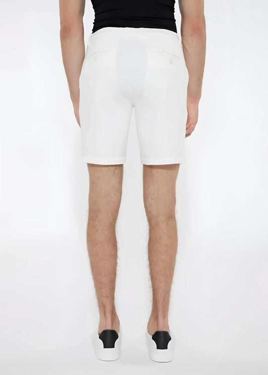 White solid stretch knit shorts with a tailored fit and subtle back pockets shown from the back side