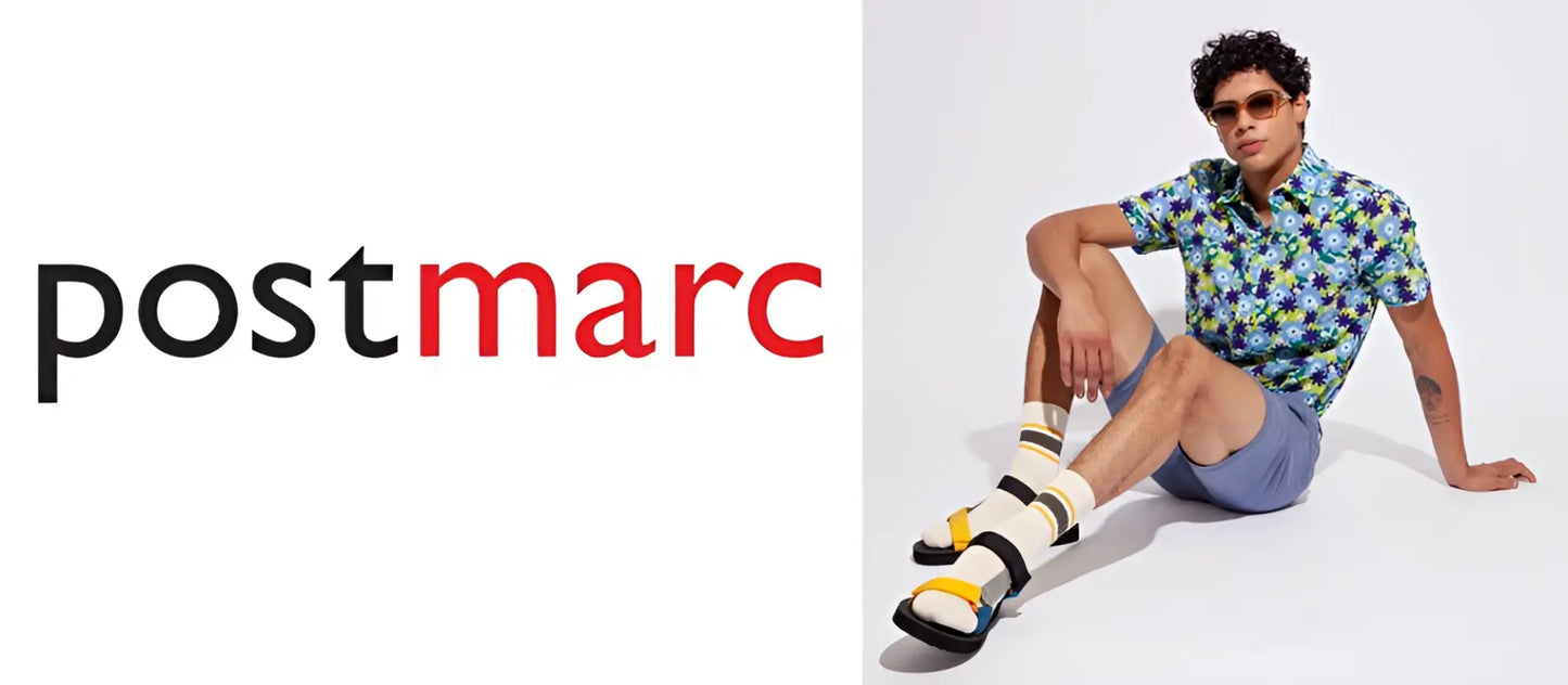 Man wearing a sorona v-neck tee in floral short-sleeved design paired with blue shorts and yellow black sandals