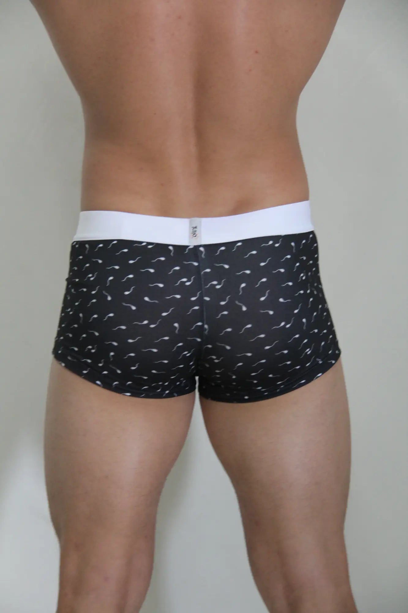 Black boxer briefs sperm trunk with white waistband and white stylized sperm pattern for casual wear