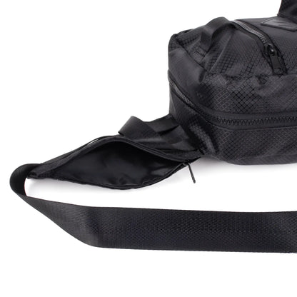 Sport crossbody sling bag in black mesh pattern with wide adjustable strap and multiple zippered compartments