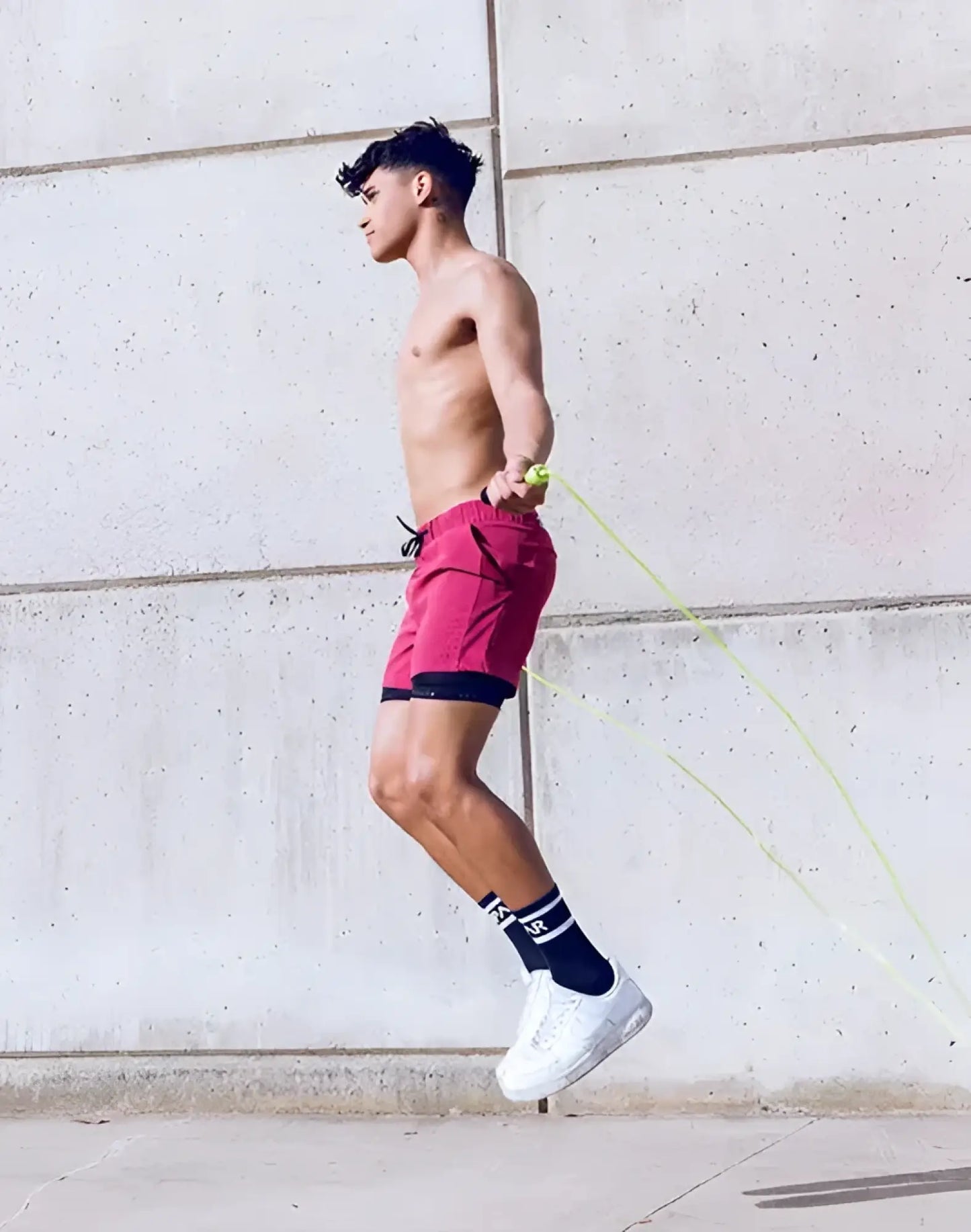 A vibrant red spr max short with black trim and drawstring waistband ideal for athletic use