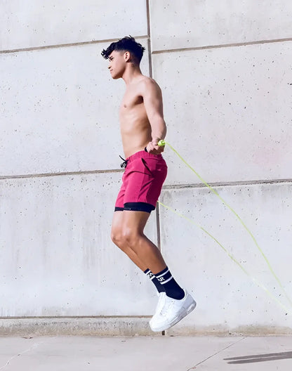A vibrant red spr max short with black trim and drawstring waistband ideal for athletic use