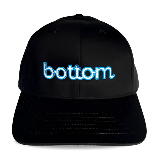 Black baseball cap with glowing blue embroidered bottom logo in spunky monkee cap design