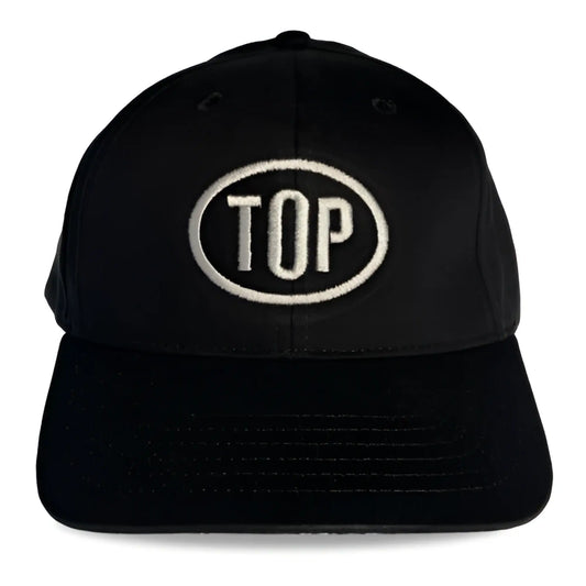 Black spunky monkee cap featuring a white embroidered top logo in an oval on the front panel