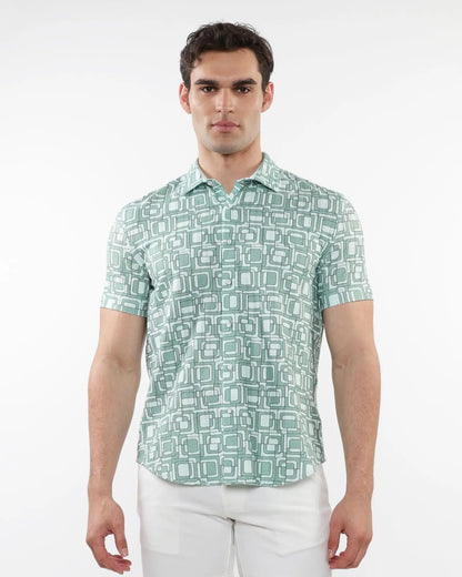 A man wearing a light green and white geometric patterned short-sleeve squares print open knit shirt