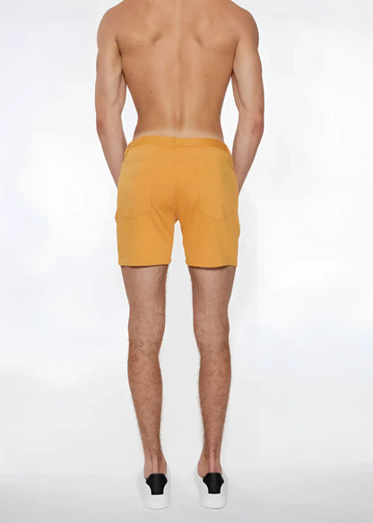 A pair of mustard-yellow st33le stretch knit shorts apricot peel with side pockets in size 29