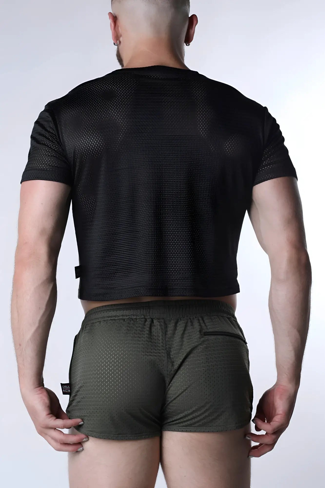 Starter mesh crop top black short-sleeved crop top with breathable textured fabric and subtle perforations on the back