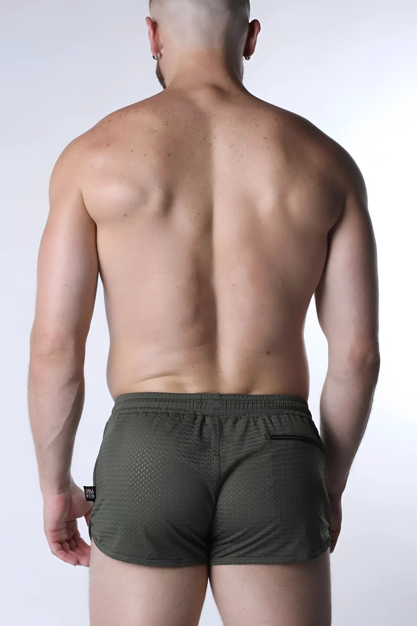 Olive green textured starter mesh athletic shorts with black side pocket and brand tag for sports use