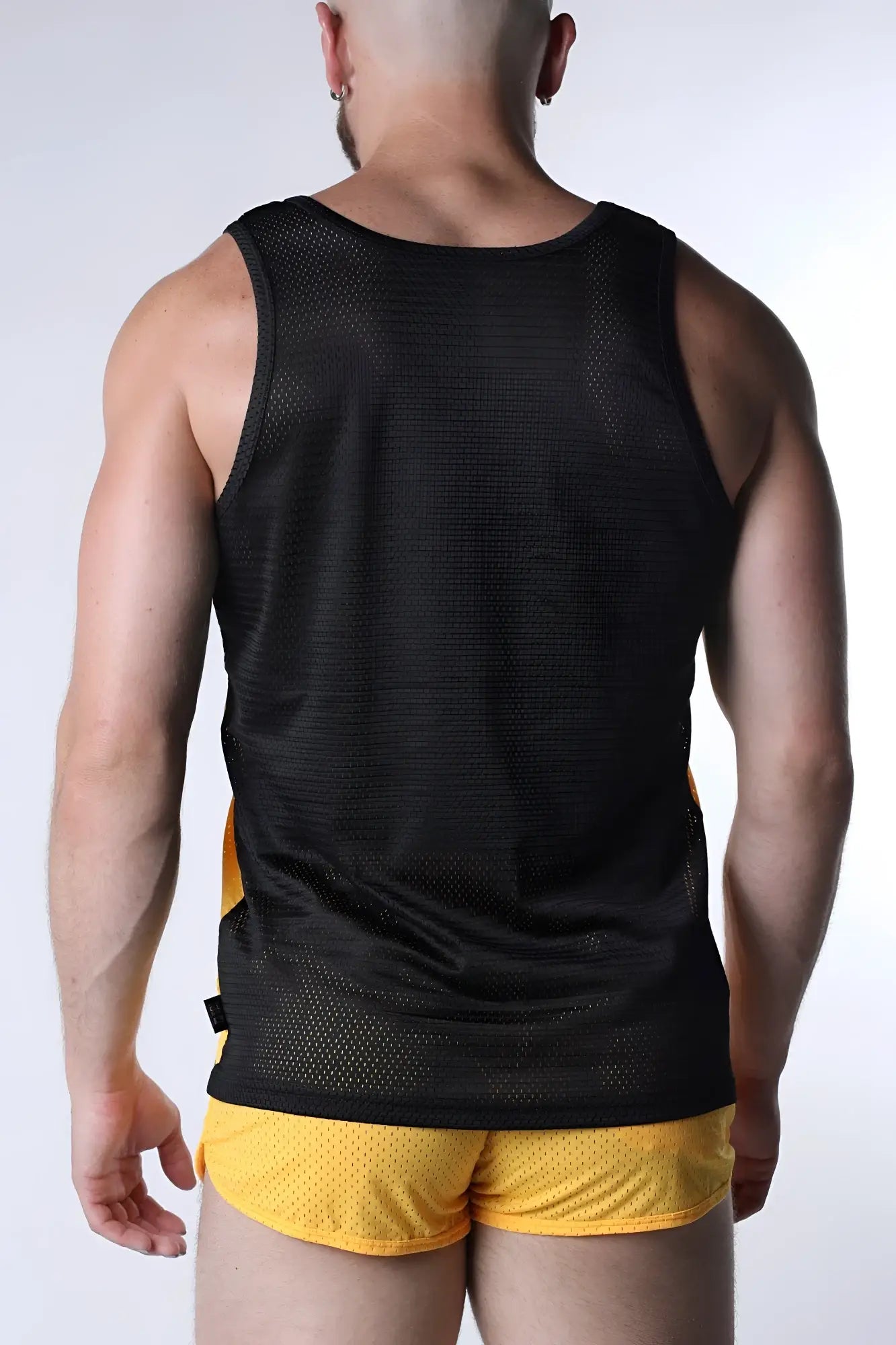 Black mesh starter tank top with yellow side panels featuring breathable lightweight fabric