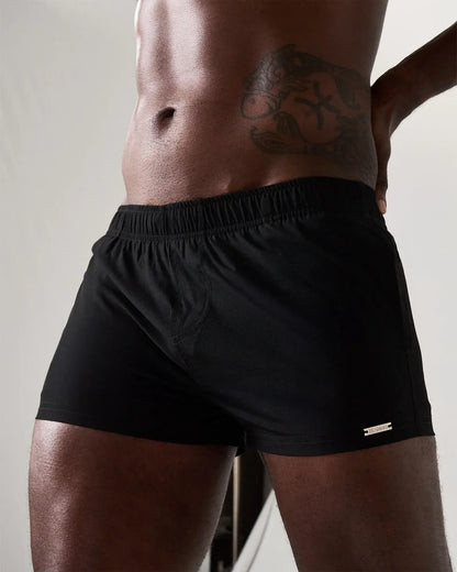 Statement swim short black athletic shorts with elastic waistband and small metallic logo on lower right leg