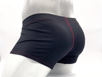 Black athletic boxer briefs with red stitching along seams displayed on mannequin for comfortable support