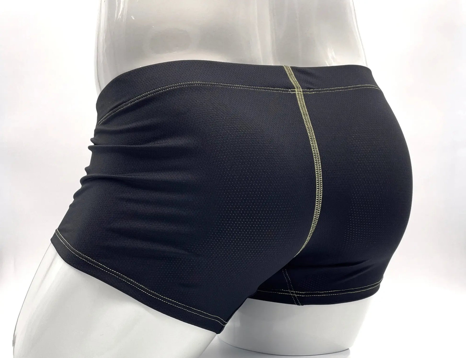 Back side of black stitch big boy pouch boxer brief with mesh texture and light green stitching along the seam