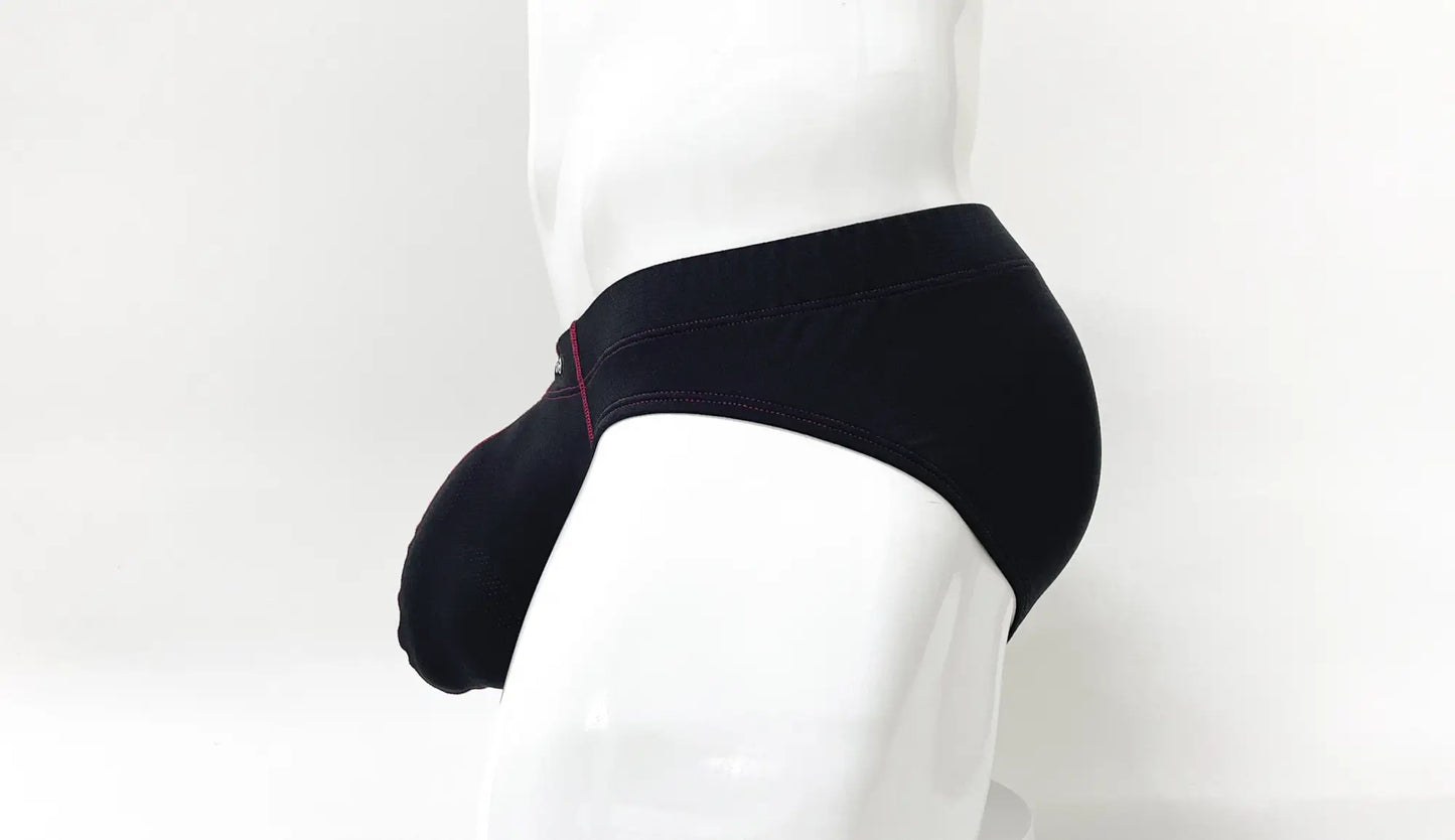 Black men’s briefs with subtle red stitching along the waistband in the stitch big boy pouch brief red style