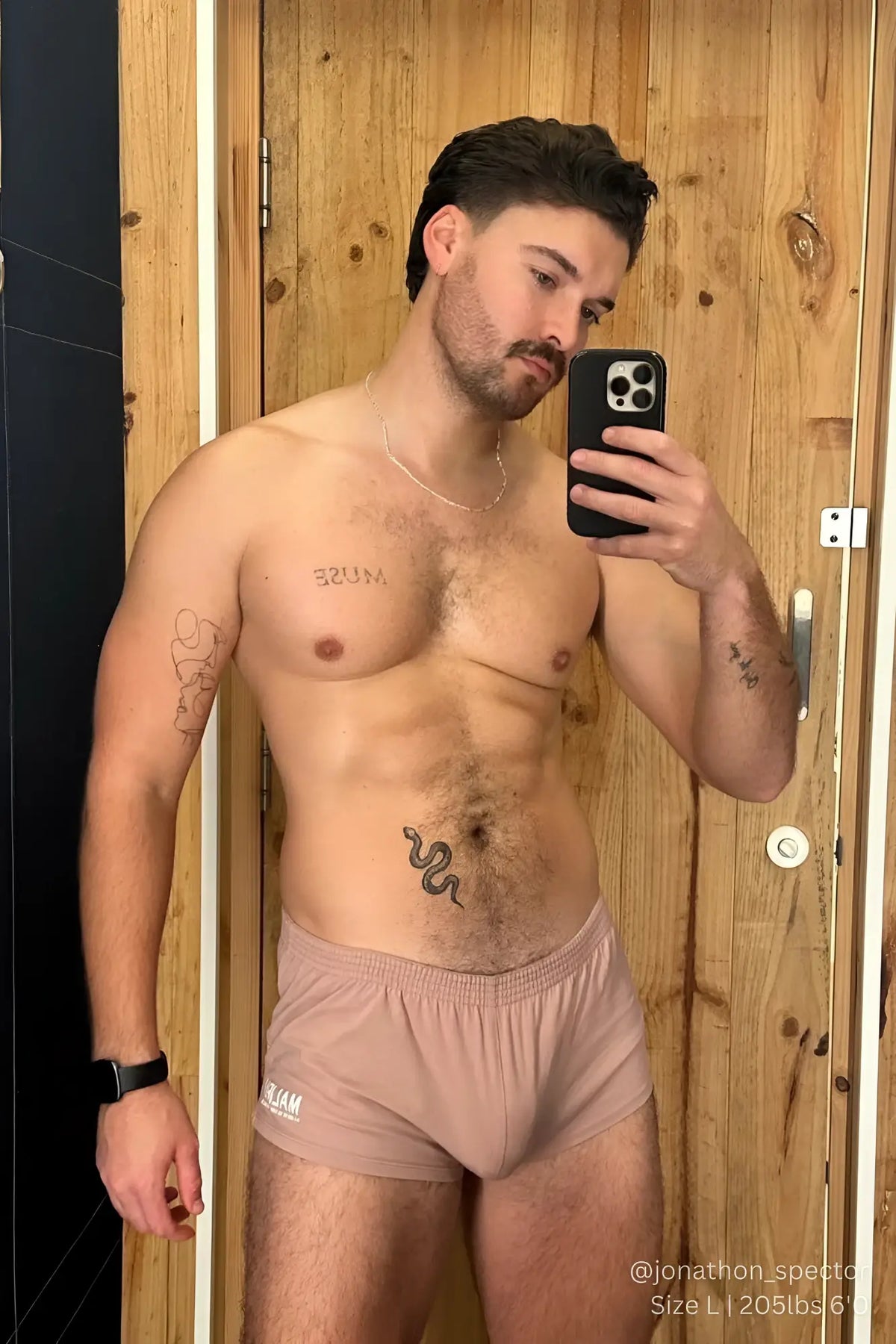A pair of stretch-it 2 inch short shorts in raspberry glace mauve soft fabric briefs with elastic waistband and team print
