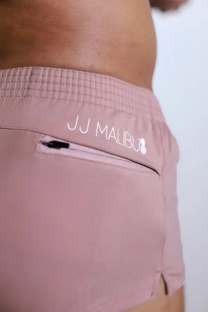 Stretch-it 2 inch raspberry glace shorts with a subtle textured waistband and white jj malibu embroidered branding