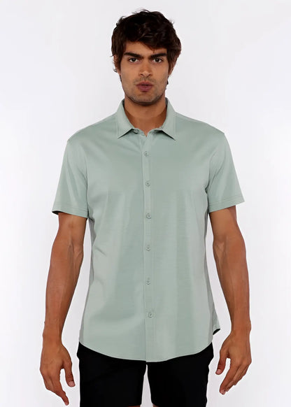 A light green stretch knit shirt with short sleeves and classic collar featuring neatly stitched seams