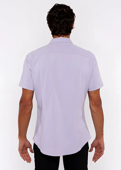 A man wearing a lavender stretch knit shirt with a classic collar and tailored fit in lightweight fabric